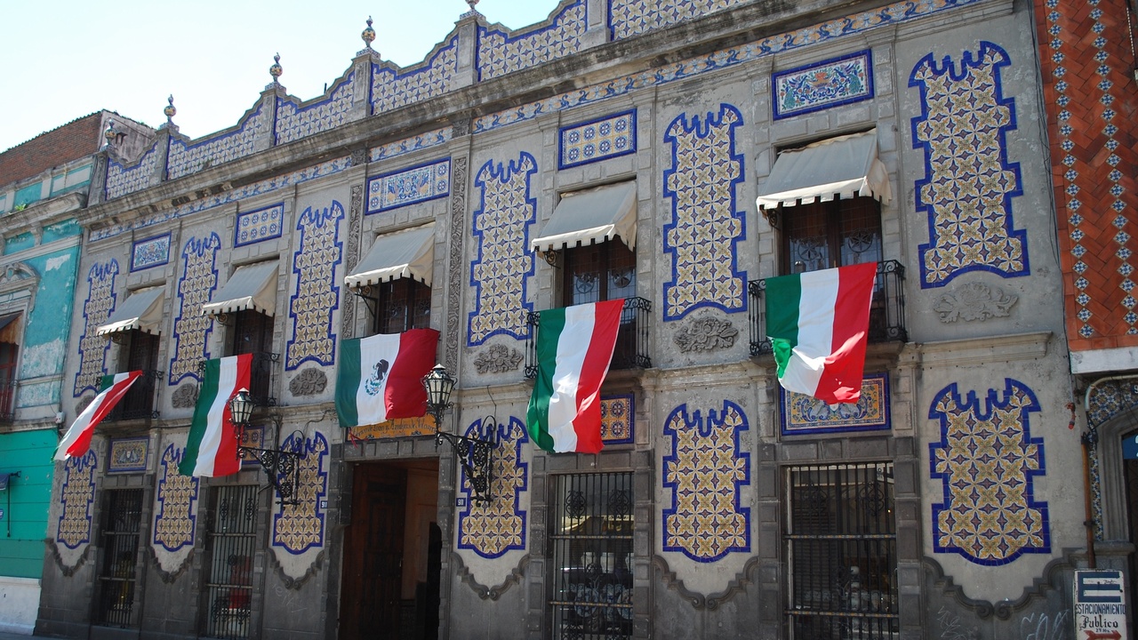 Talavera pottery workshop with artisans painting tiles and Museo Amparo facade