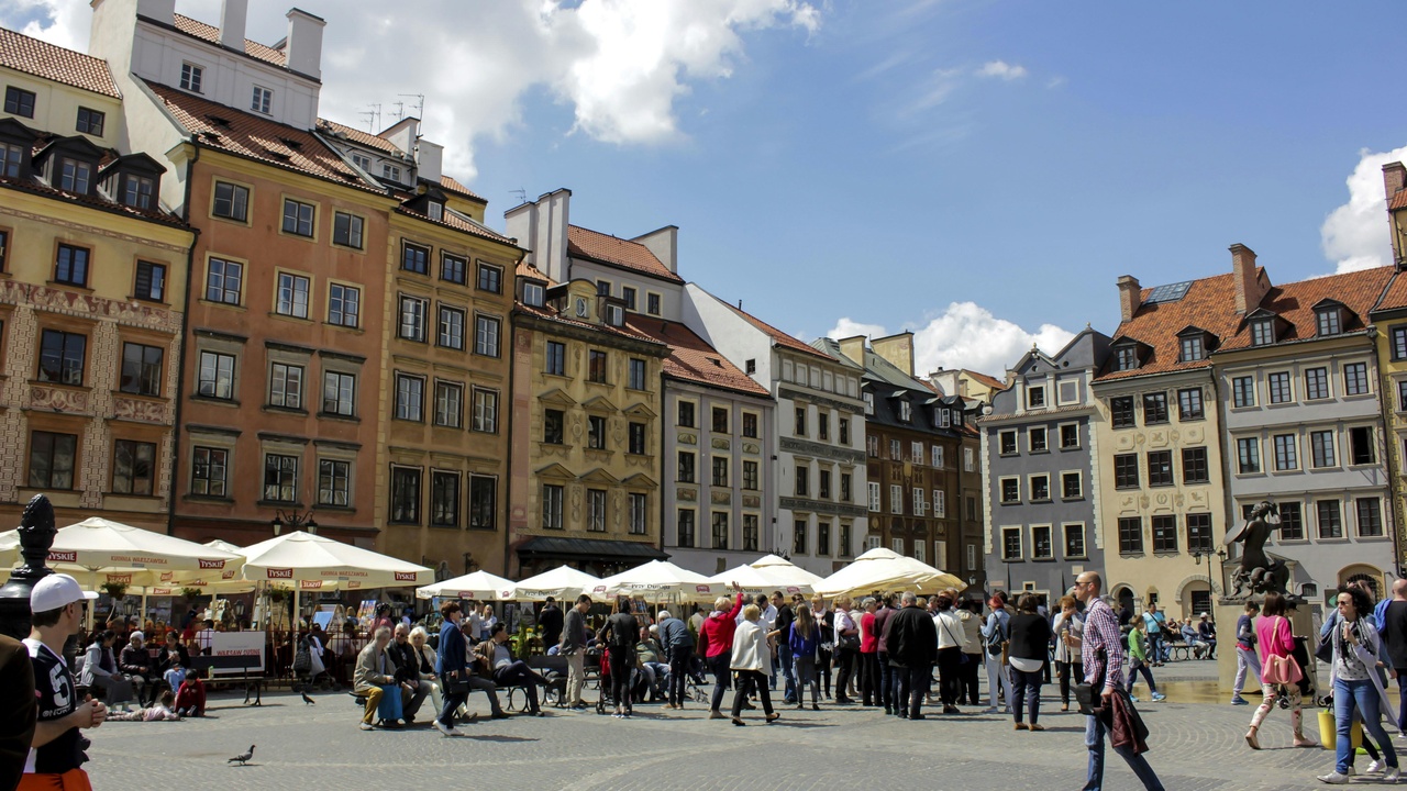 Crowded Main Market Square and tram showing tourism and city life challenges