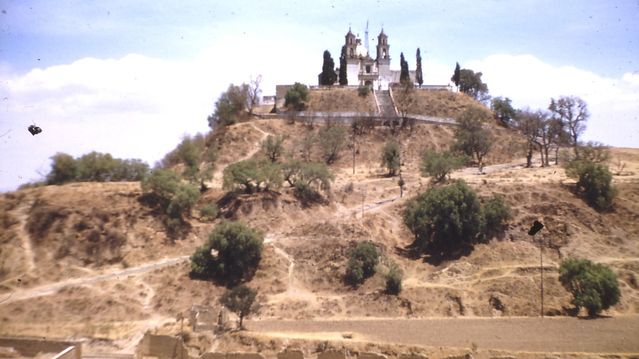 Great Pyramid of Cholula with the Iglesia de Nuestra Señora de los Remedios on top and Popocatépetl in the distance