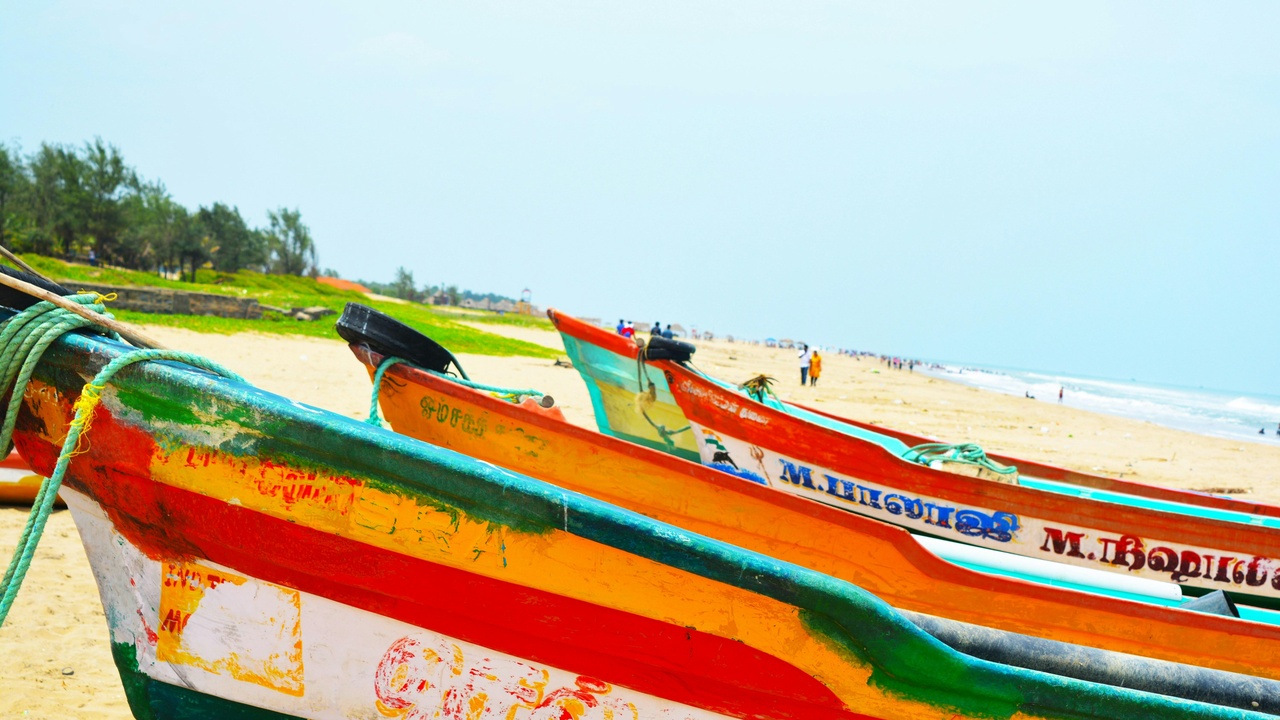 Beach scene with tourists and a crowded night market on the coast of Vietnam
