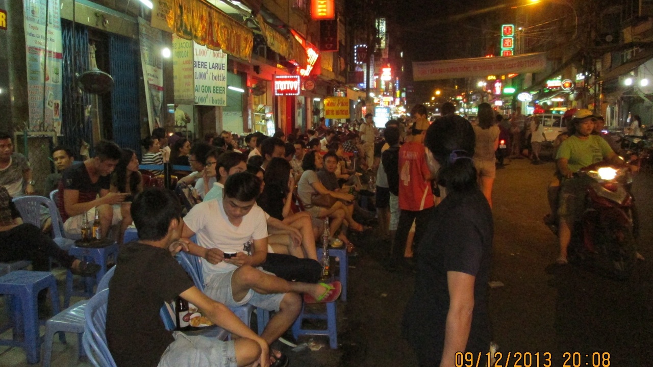 Ho Chi Minh City street life and motorbike traffic in a crowded urban market