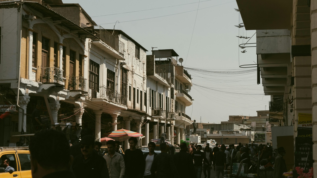 Crowded urban streets and a municipal police patrol in a Jordanian neighborhood