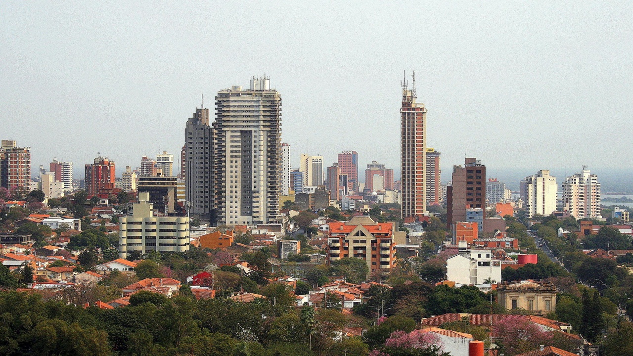 Asunción skyline with traffic and riverfront at dusk