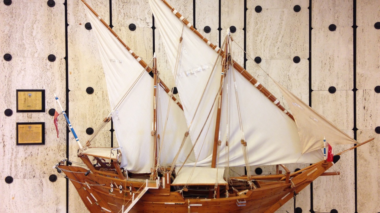 Traditional Kuwaiti dhow on the Persian Gulf at sunset, representing maritime heritage