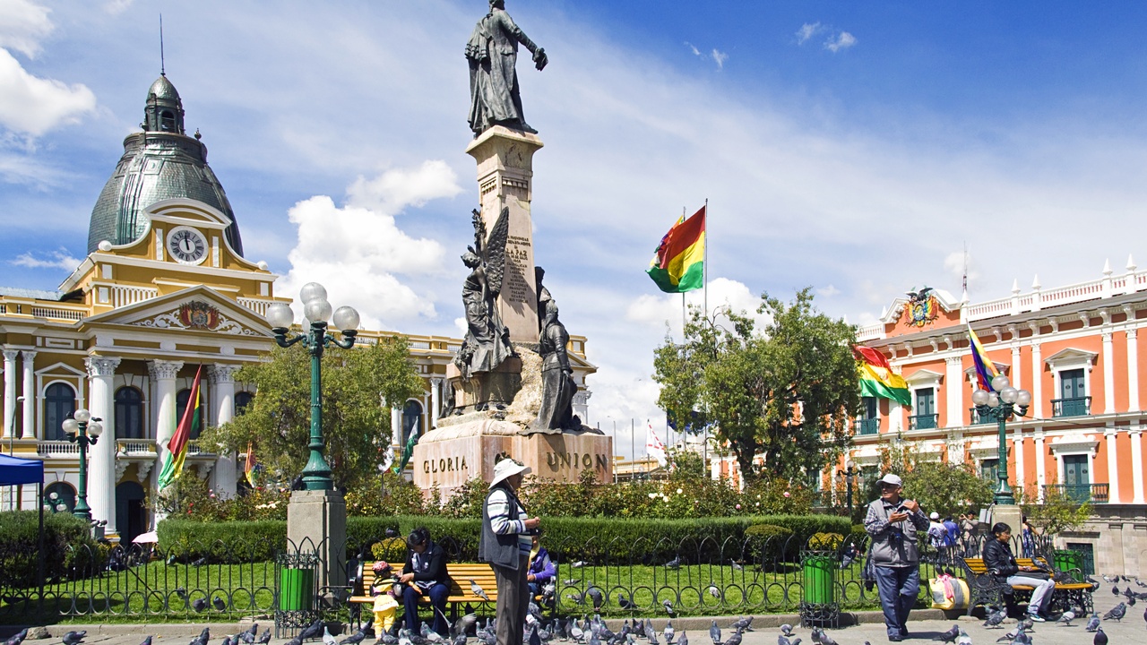Plaza Murillo with colonial buildings and people walking in La Paz