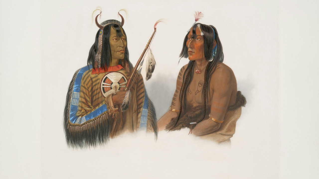 Museum exterior with warm desert light and a pathway leading to a gallery entrance, palms and agave nearby.