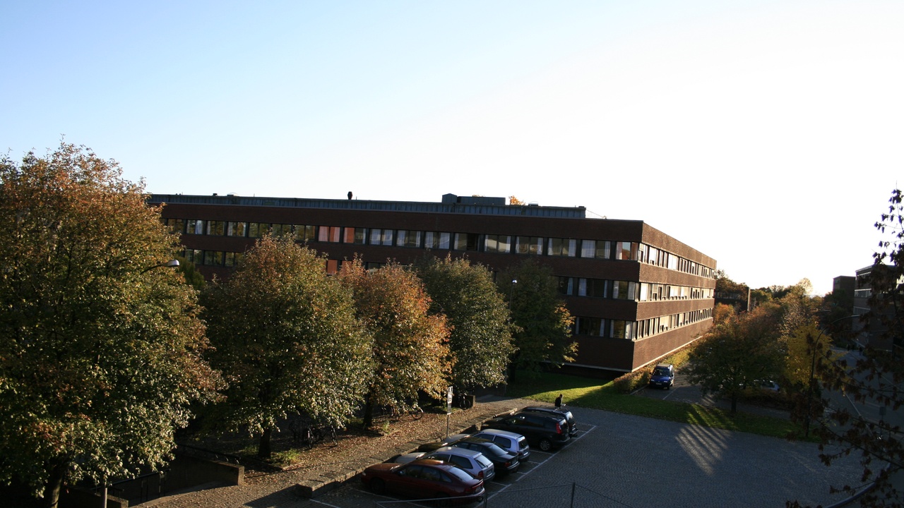 University campus building with students walking between classes