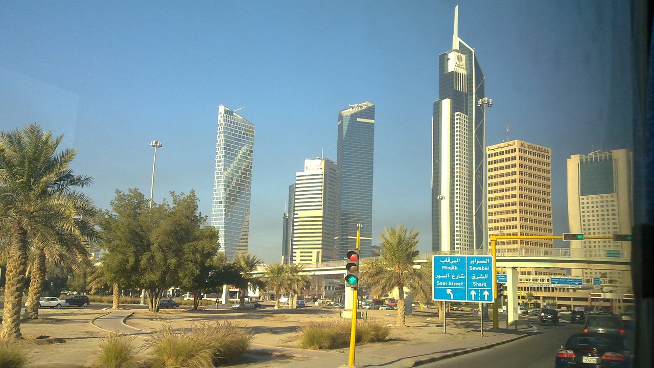 Kuwait Towers illuminated against evening sky, an iconic modern landmark