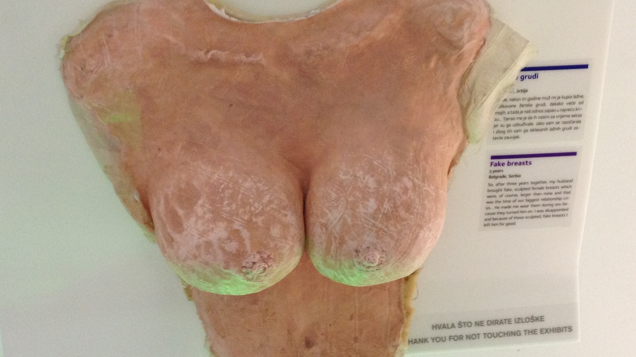 Interior display at the Museum of Broken Relationships showing personal artifacts and handwritten notes.