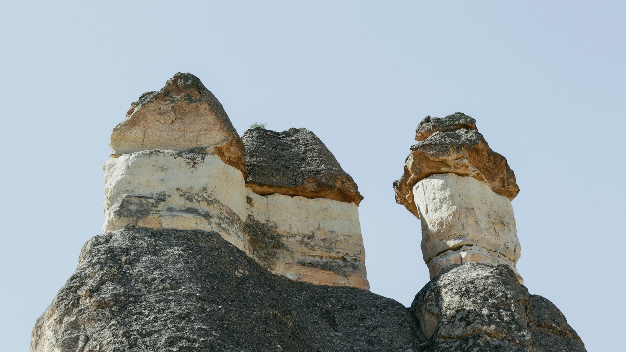 Ennedi sandstone arches with sunset over Tibesti peaks and Lake Chad shoreline views