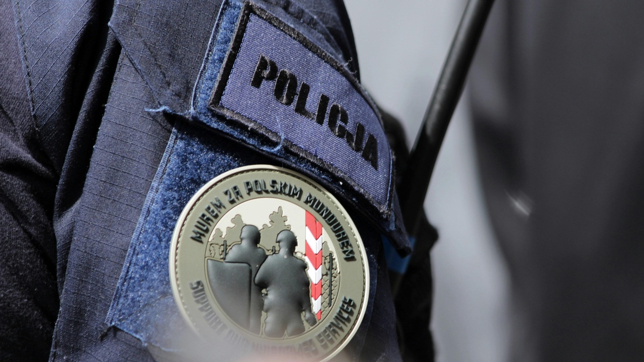 Regional Czech city center at night with tram and pedestrian traffic