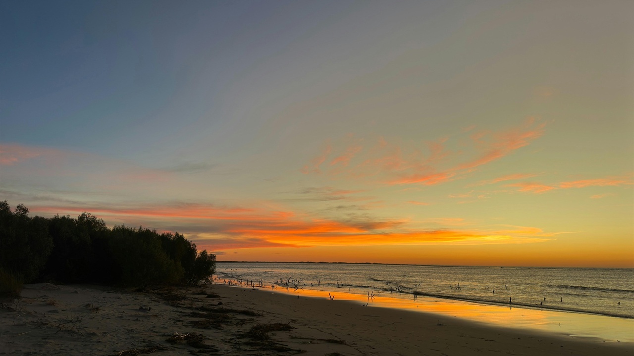 Wailea beach resort at sunset with calm water and palm trees