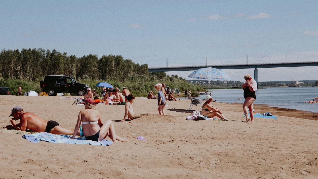 Crowded summer beachfront festival with policing and emergency services visible