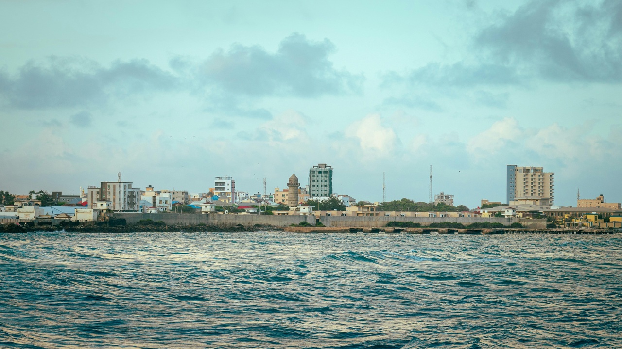 A busy open-air market in Mogadishu with textiles and spices on display