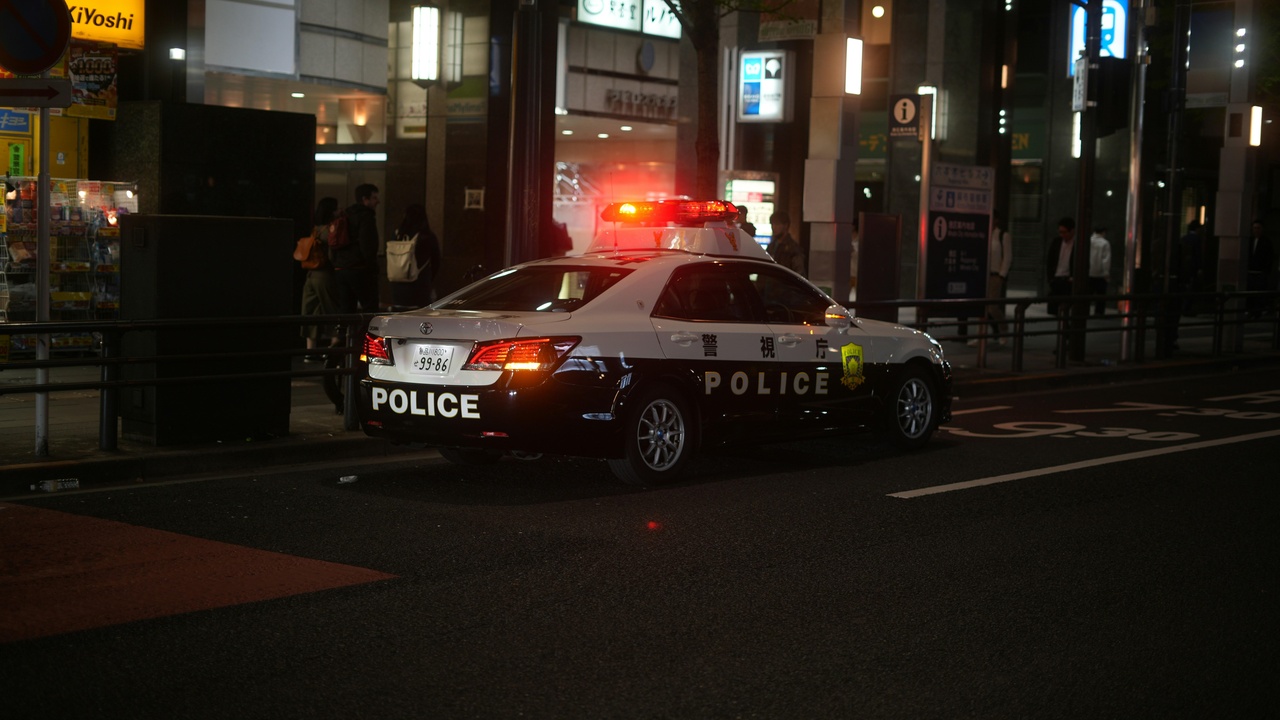 Urban nightlife district with police patrols in a Japanese city