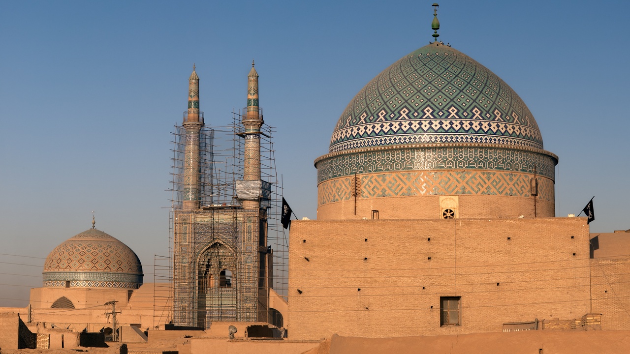 Traditional Afghan family gathering celebrating Nowruz with food and dance.