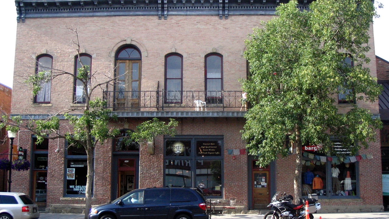 Interior of a Bozeman brewery with people sampling beer and plates of shared small dishes