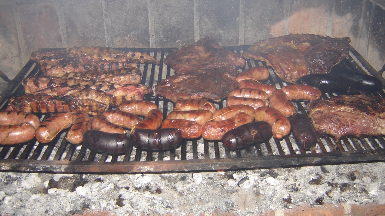 A sizzling parrilla grill with various cuts of beef, and a classic café setting with medialunas on a plate.