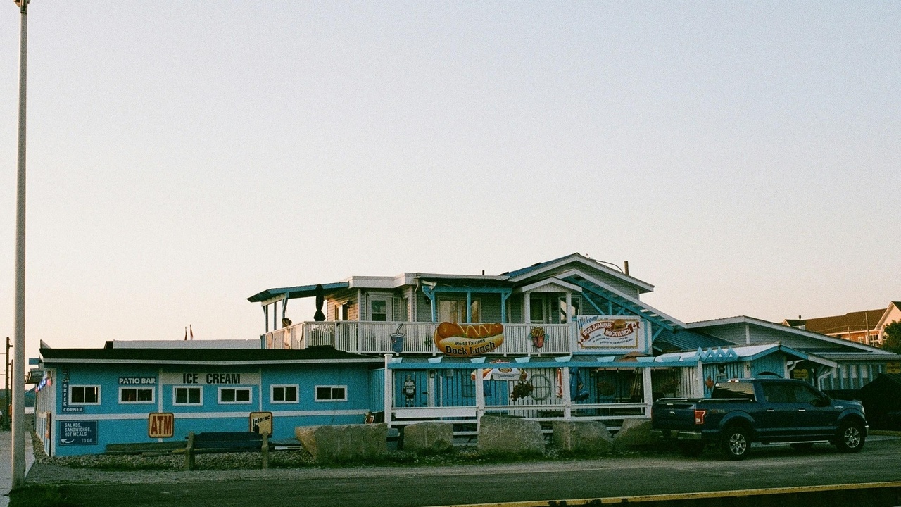 Oceanfront dining at Malibu Farm with wooden tables and sea view.