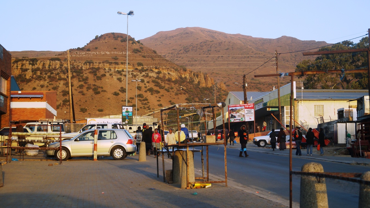 A mid-sized Lesotho market town at dusk illustrating infrastructure and lighting challenges