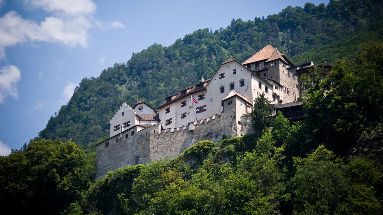 Vaduz Castle with Liechtenstein flag and princely family portrait