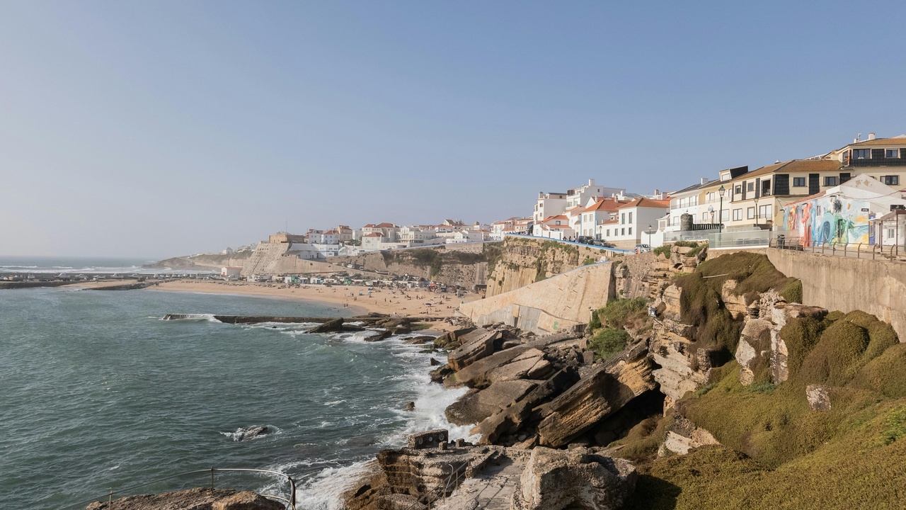 Ericeira town life with surfers and fishing boats on the coast