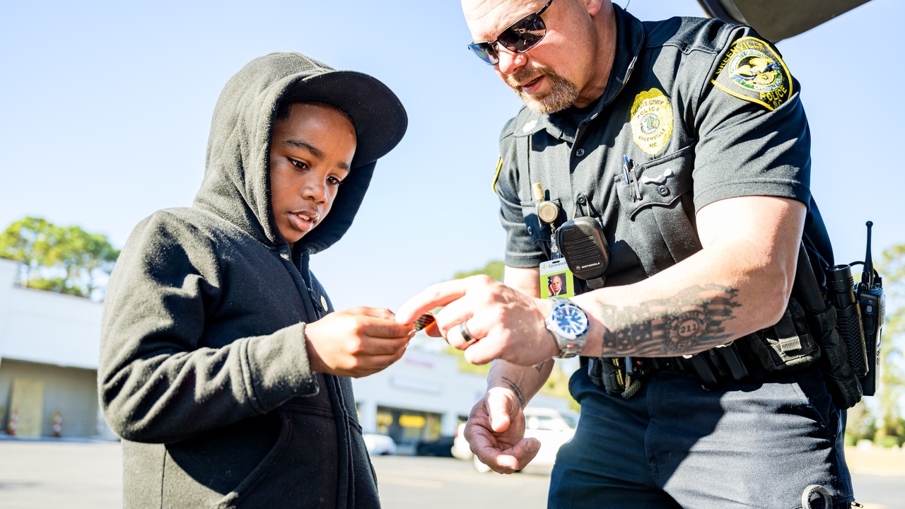 Police officers walking a neighborhood during community policing in a North Carolina suburb