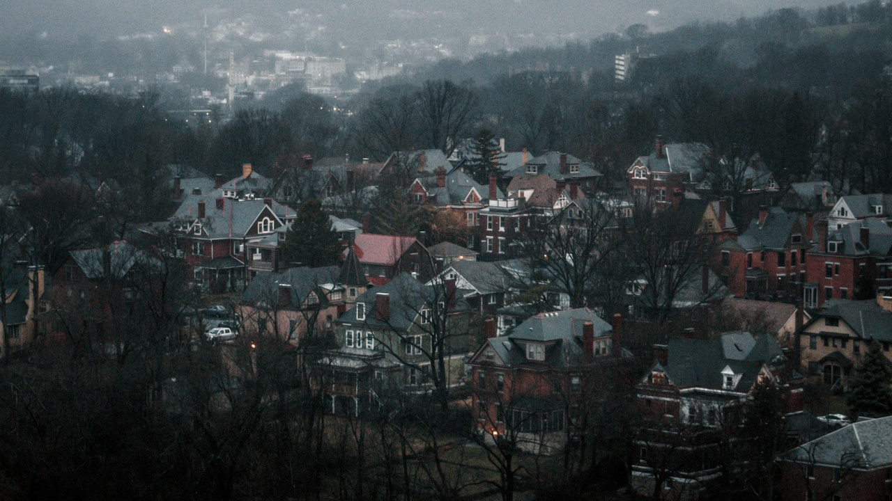Main street or aerial view showing a small Pennsylvania town with residential streets and low traffic.