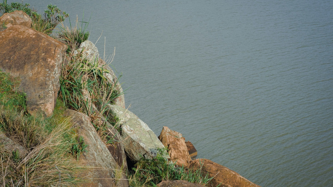 Cliff-top view from Point Dume looking at Malibu coastline at sunset.