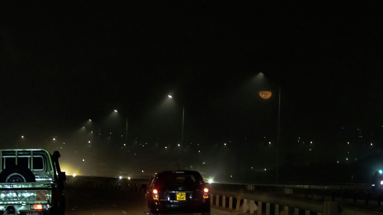 Kampala traffic and urban motorbike taxis at dusk