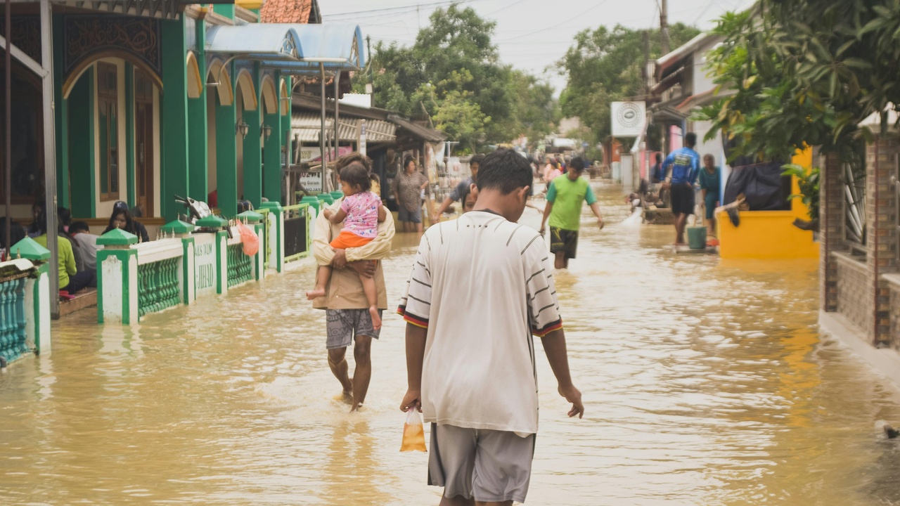 Flooded street and nighttime market activity in a Beninese town