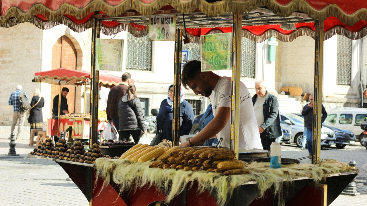 Street vendor serving koshari in Cairo from large brass pots