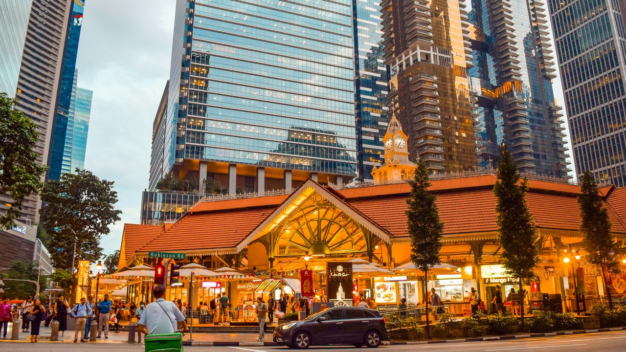 Hawker centre stalls and diners sampling local dishes.