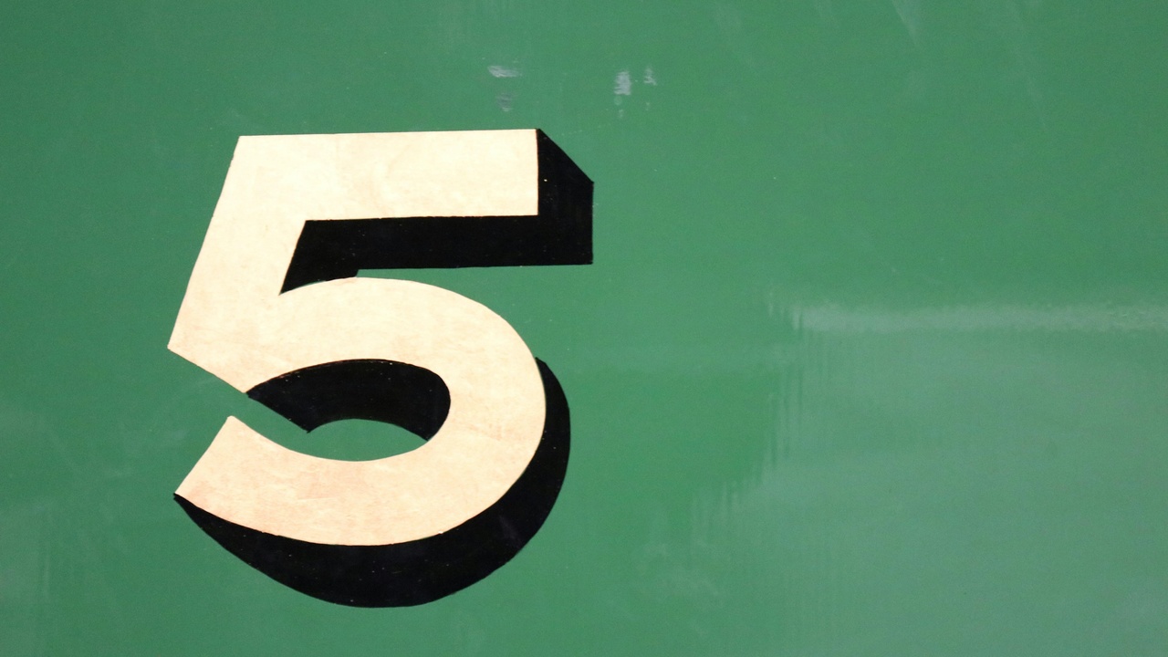 A rugged 4x4 winding up Sani Pass with dramatic cliffs on both sides