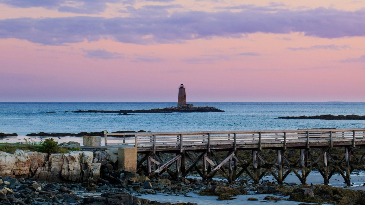 Maine coastline with rocky shore and boats near Acadia National Park