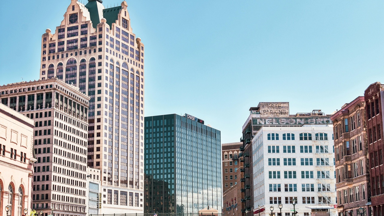 Milwaukee skyline with patrol car in foreground illustrating urban crime in a Wisconsin city.