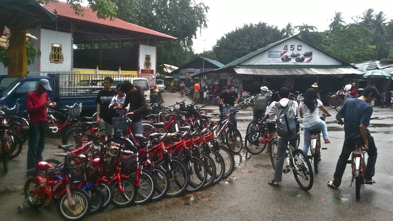 Cyclists on Pulau Ubin with rustic paths and island greenery