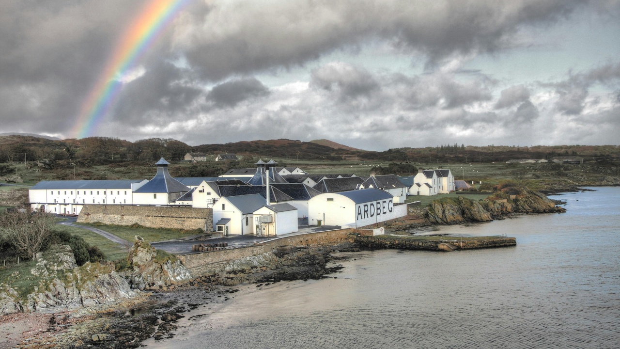 Scottish whisky bottles and seafood dishes on a wooden table