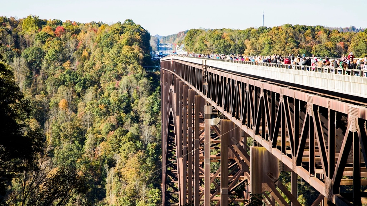 Skydiver freefalling over coastal landscape at sunset