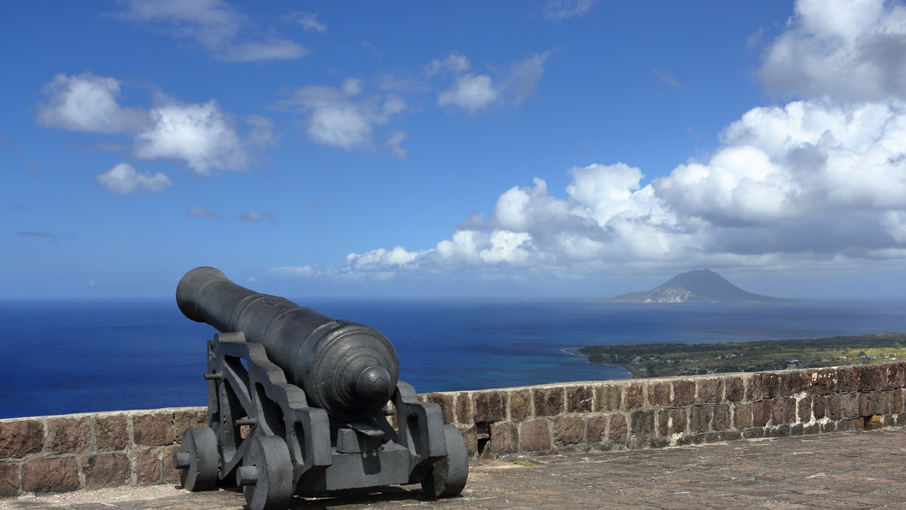Brimstone Hill Fortress on a ridge, cannon and stone ramparts overlooking green hills