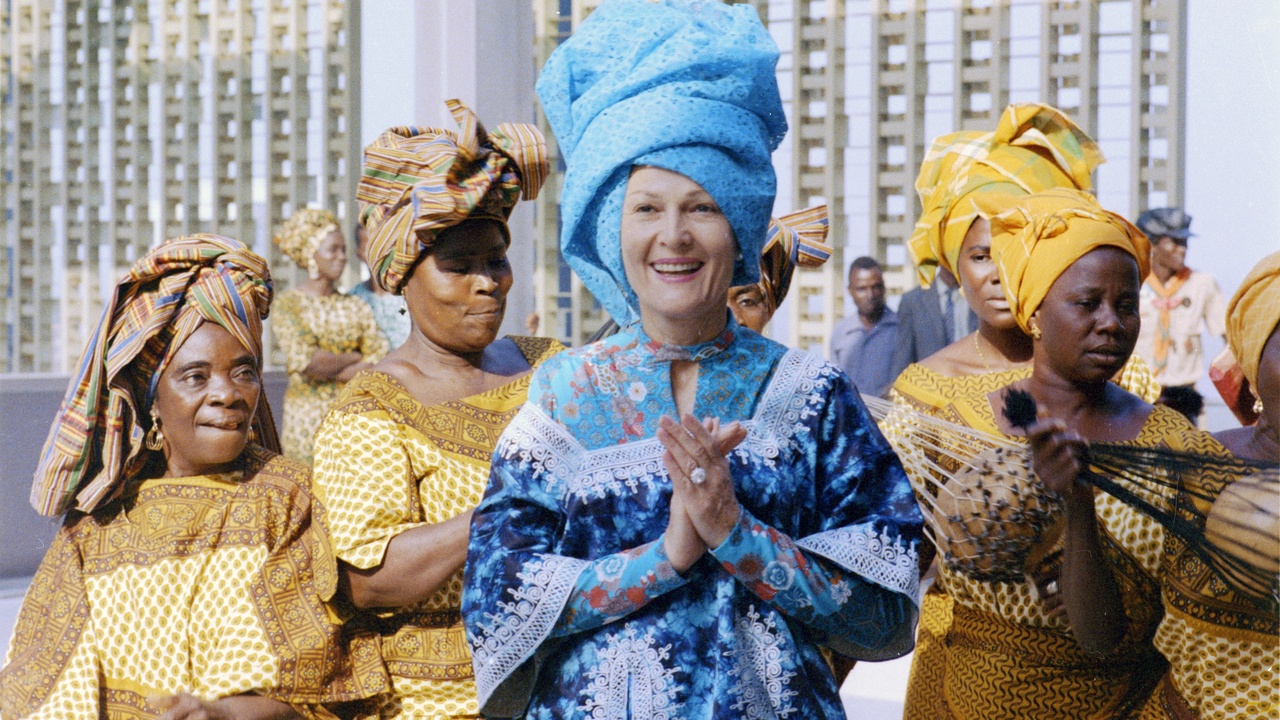 Members of a Liberian secret society performing a masked dance at a village ceremony