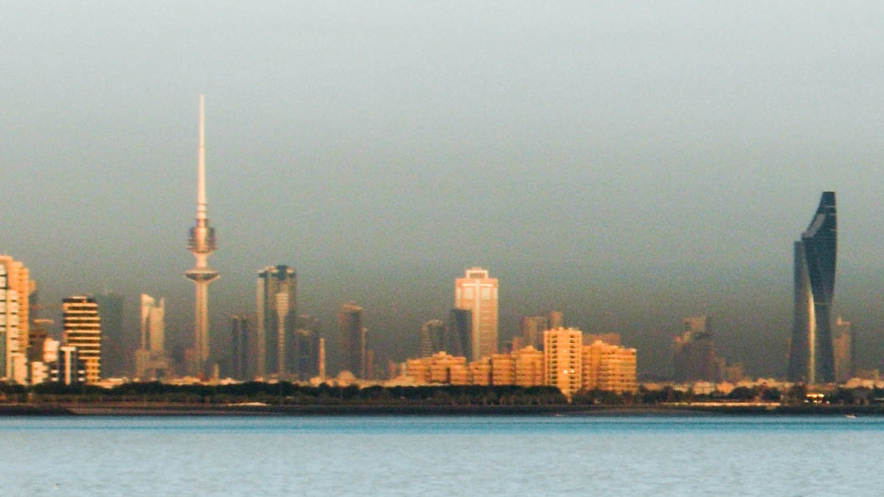 Kuwait skyline with oil infrastructure and Kuwaiti dinar imagery