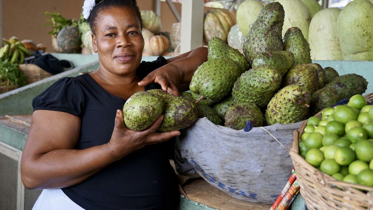 Small Haitian business owner sorting crafts for export