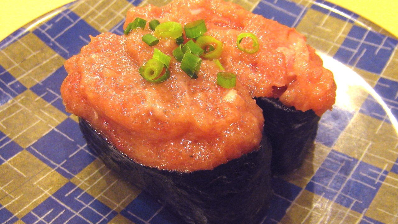 Street food stalls and sushi at Tsukiji Outer Market in Tokyo
