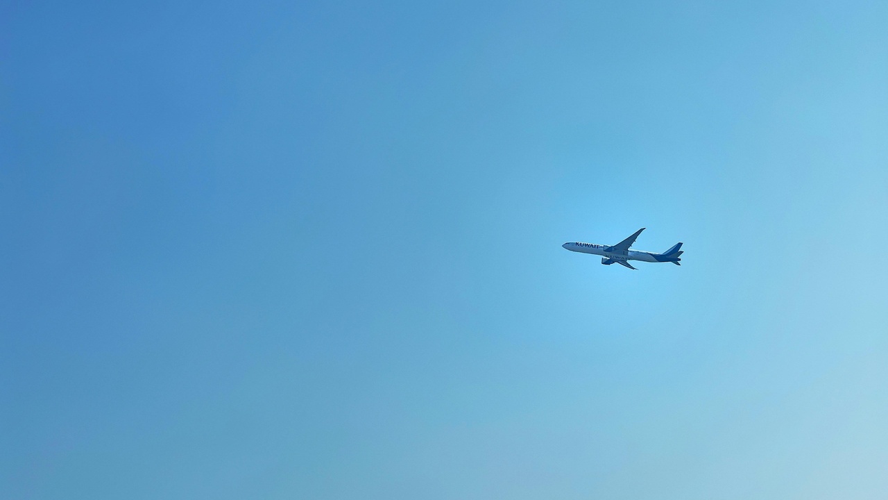 Kuwait International Airport terminal and urban highway infrastructure.