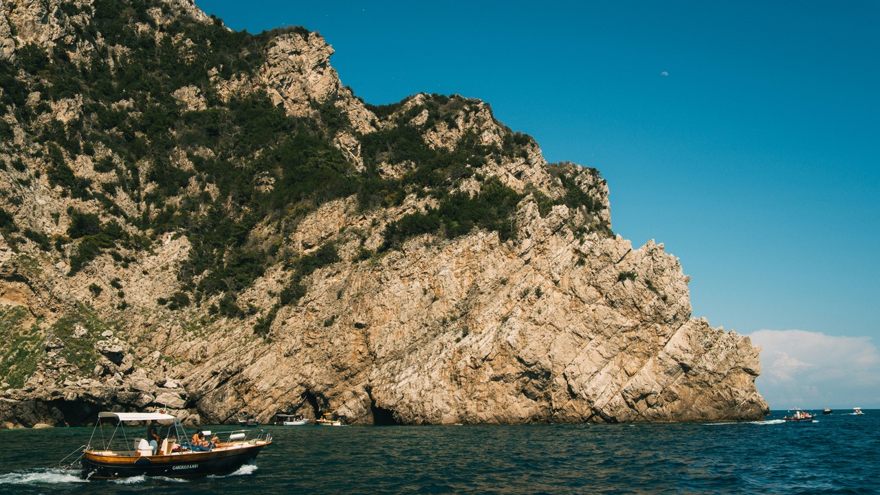 Sea kayaking near Capri and Punta Carena lighthouse at sunset