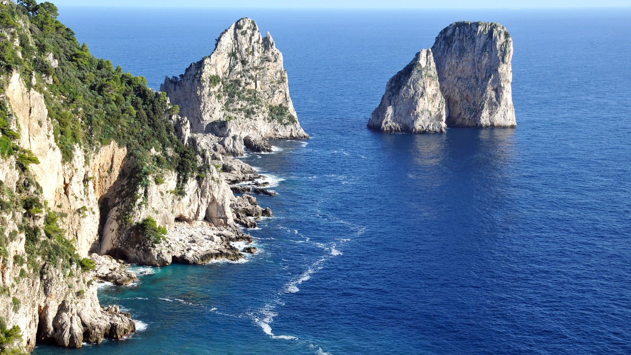 Capri coastline with Faraglioni rocks at sunrise
