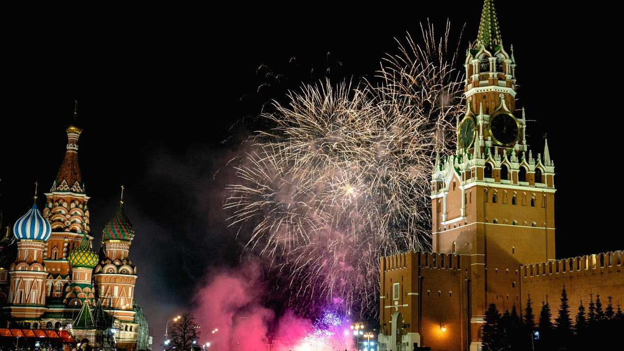 Maslenitsa festival with people around a bonfire, pancake stalls and a burning effigy
