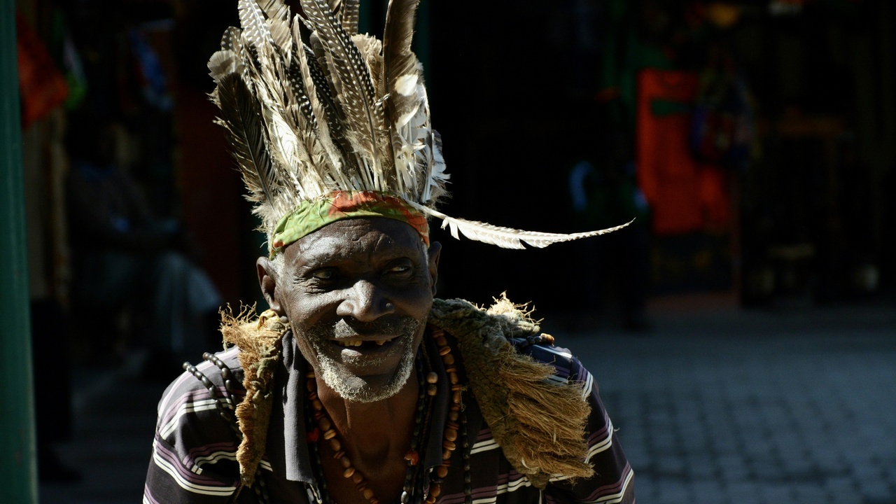 Artisan weaving baskets and a traditional healer consulting with a patient