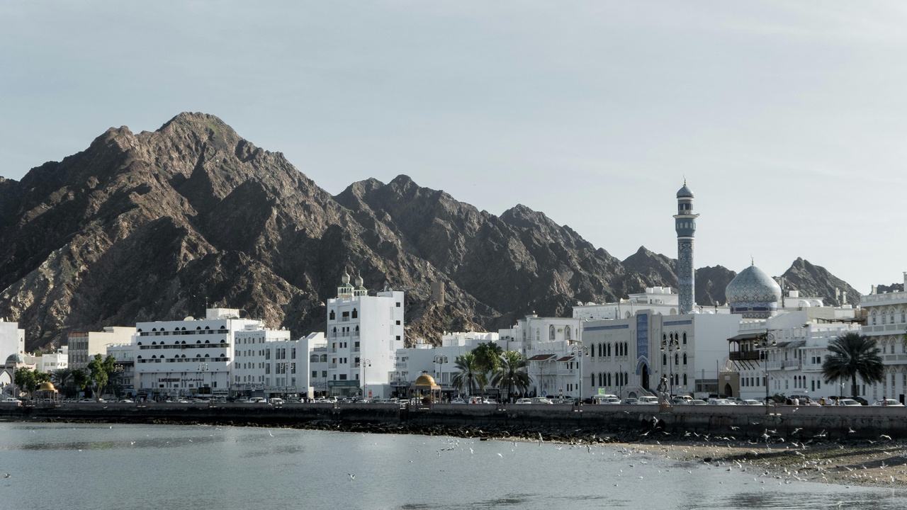 Industrial port and busy urban traffic in Oman
